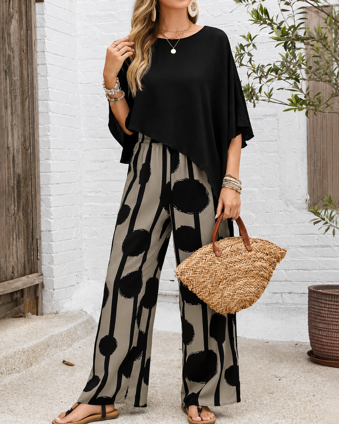 Bernice black poncho-sleeve top with wide-leg printed pants, front view