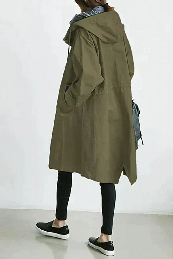 Edna oversized waterproof trenchcoat in army green, back view walking