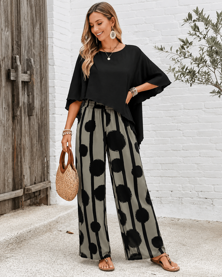 Bernice two-piece set worn with black top and wide-leg patterned pants, styled outdoors