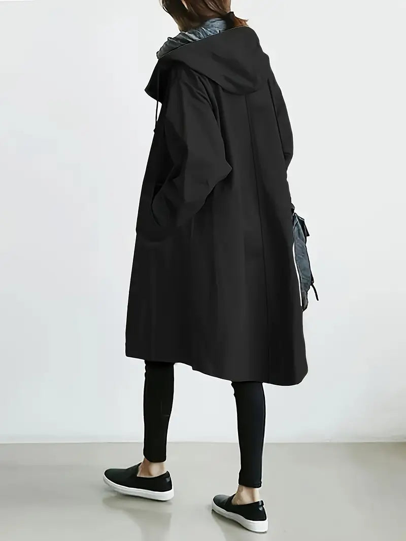 Edna oversized waterproof trenchcoat in black, back view walking