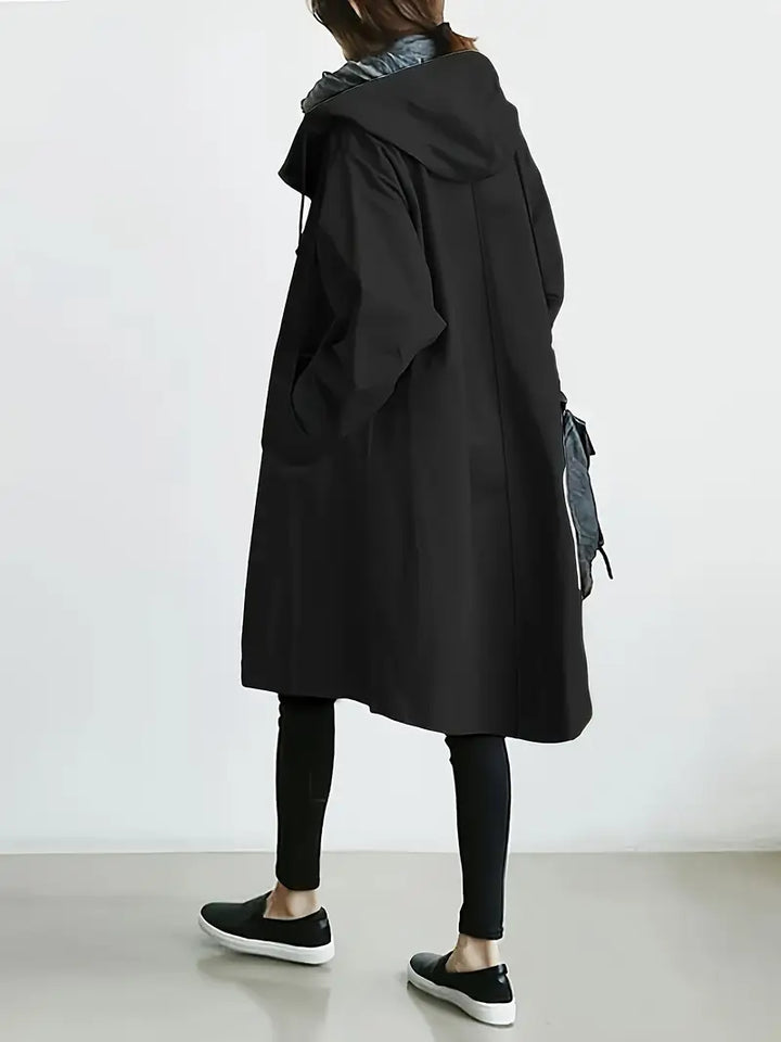 Edna oversized waterproof trenchcoat in black, back view walking