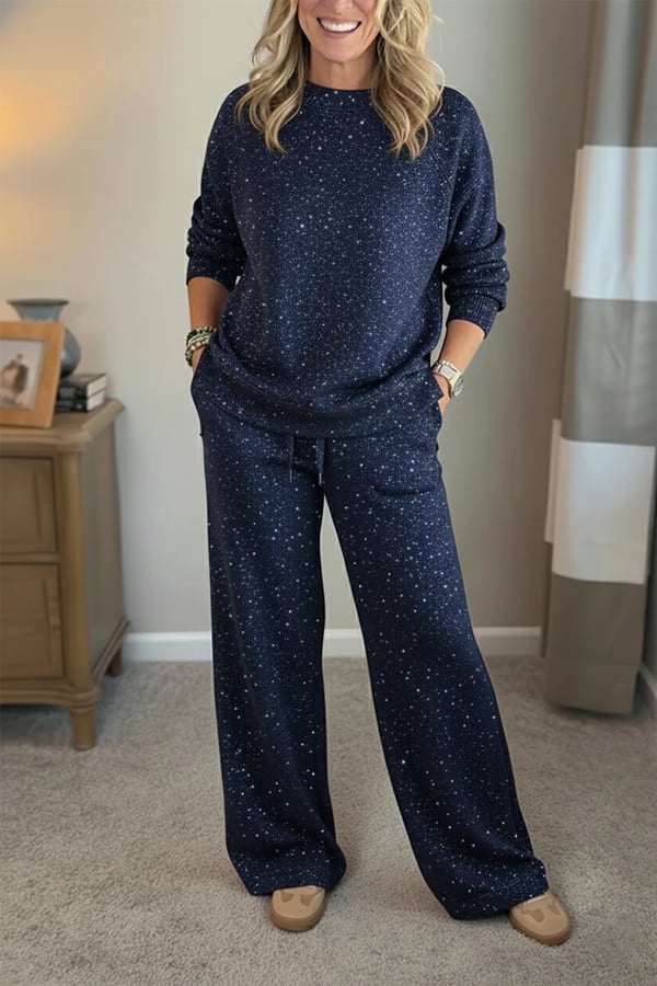 Woman wearing a navy shimmer crewneck sweatshirt and matching wide-leg pants, close-up